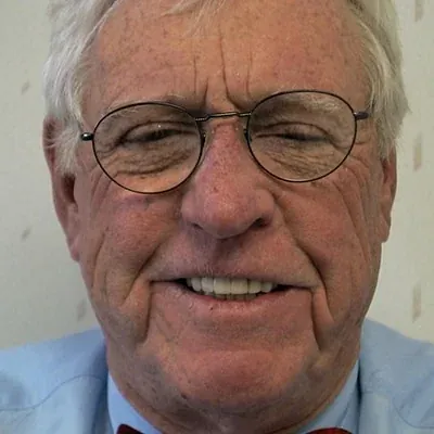 An elderly man showing his new smile from Dr. Bjorklund.